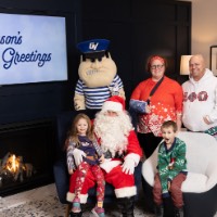 Surprised little boy and family with Louie and Santa